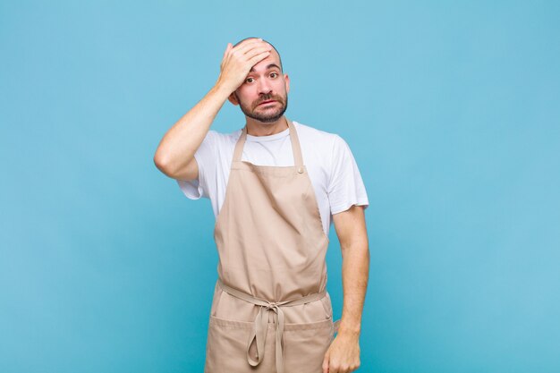 Bald man panicking over a forgotten deadline, feeling stressed, having to cover up a mess or mistake