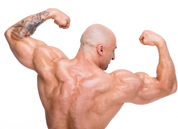 Bald man shows back muscles