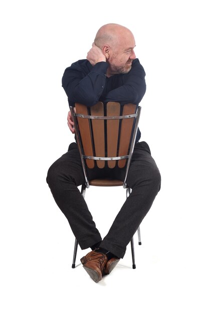 Bald man sitting on white background, look side