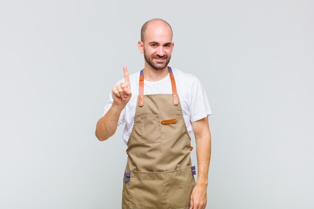 Bald man smiling and looking friendly