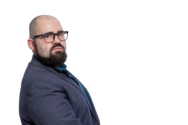 A bald man with glasses and a beard in a blue formal suit Elegance and corporate style Isolated on white background Space for text