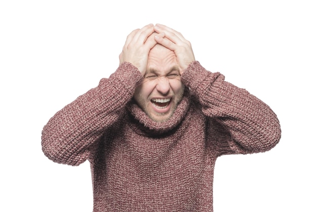 Bald unshaven man holding hands to head and shouts Isolated