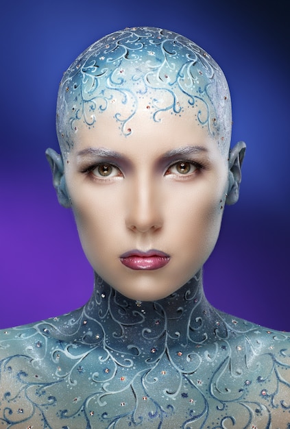 Bald woman with colorful make-up art.