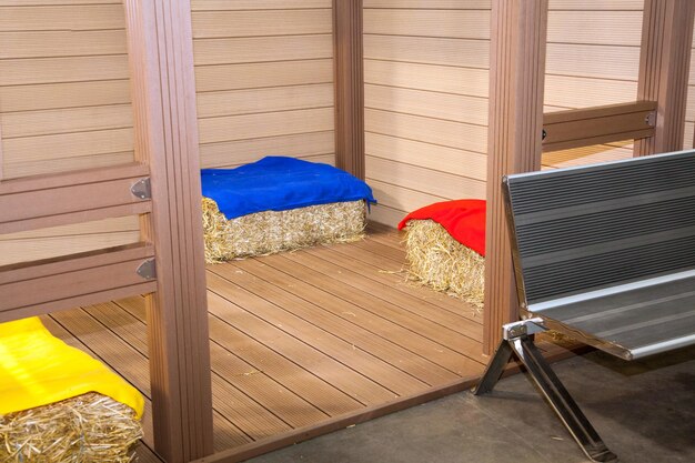 Bales of hay on floor near wooden walls