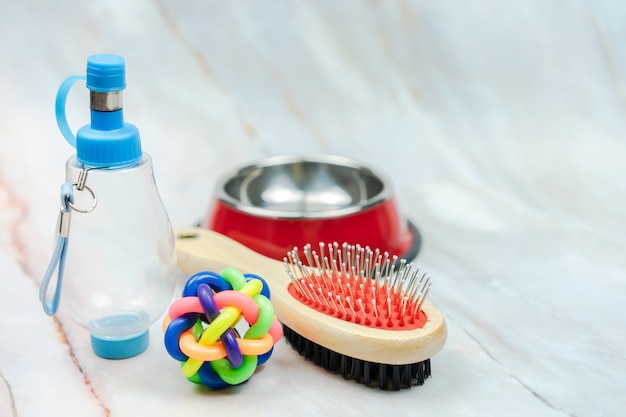 Ball, Brush and water bottle for dog with copy space