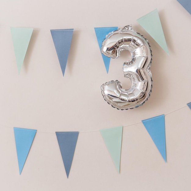 Photo the ball in the form of numbers 3 and a garland of blue flags birthday decorations