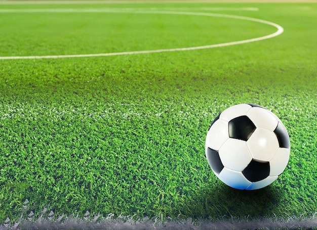 Ball on the green field at soccer stadium ready for game