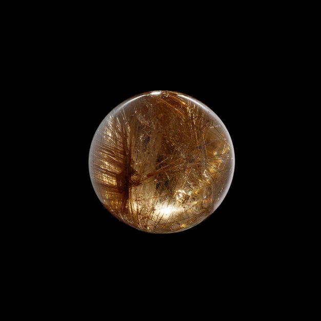 Ball of quartz with rutile on a black background closeup