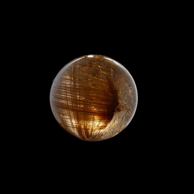 Ball of quartz with rutile on a black background closeup