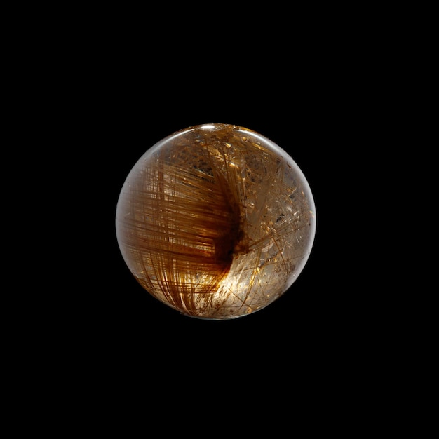 Photo ball of quartz with rutile on a black background closeup