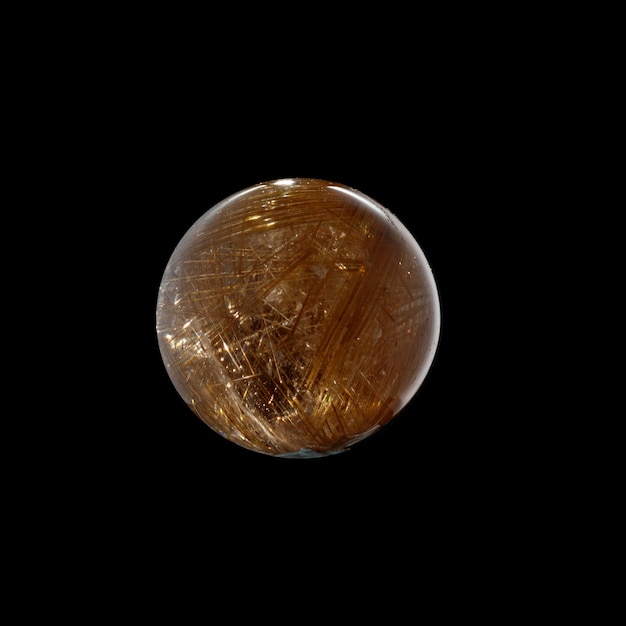 Ball of quartz with rutile on a black background