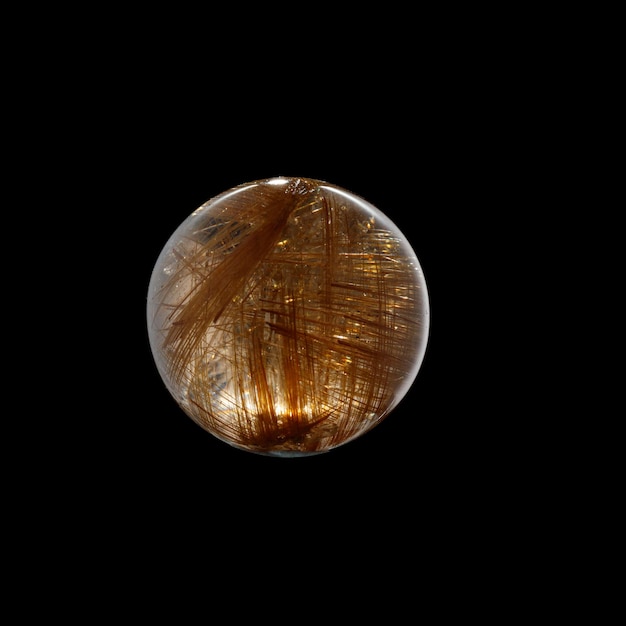 Ball of quartz with rutile on a black background