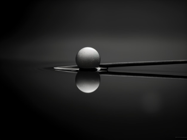 A ball and sticks are on a reflective surface.