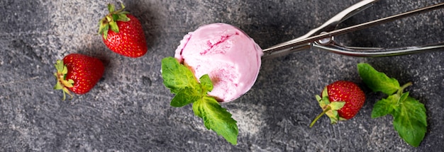 Ball of strawberry ice cream in scoop