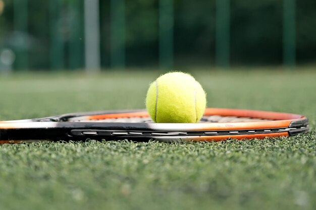 Ball and tennis racket closeup ball and racket on the tennis court