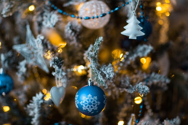 a ball with a picture of a snowflake hanging on a tree