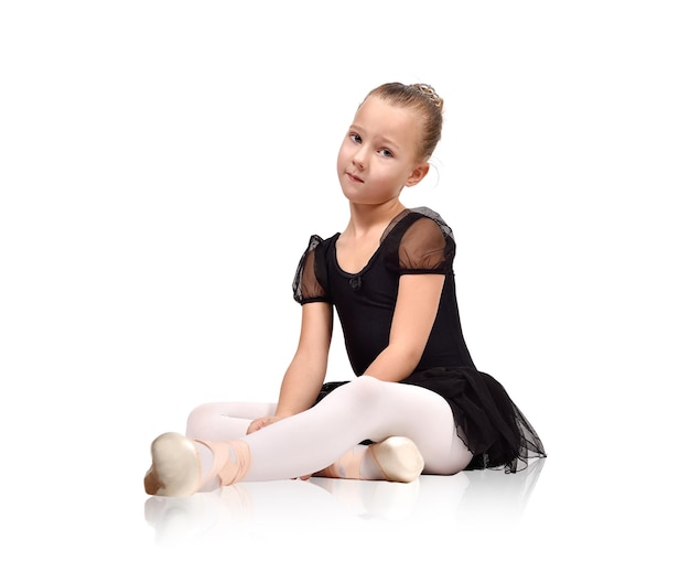 Ballerina in black tutu sitting