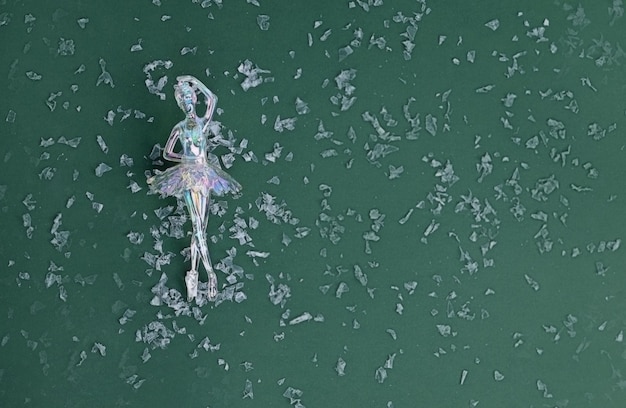 ballerina on a green background with artificial snow