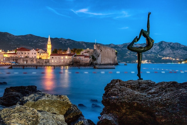 Ballerina statue and Budva Old town at background in Montenegro