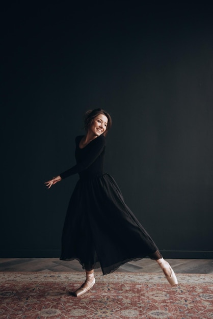 Ballet dancer on the black background