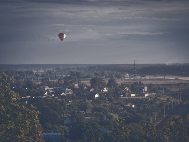 Balloon flying over the village in the night Russia