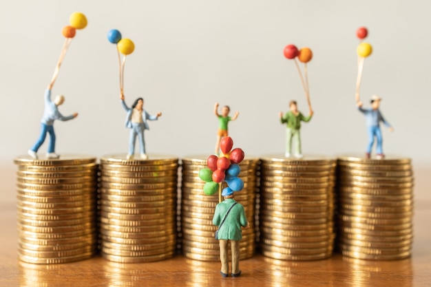 Balloon Seller man miniature figures people standing with children on top of stack of coin