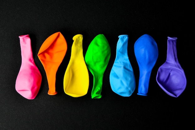 Balloons in rainbow colors on a black background