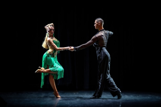 Ballroom couple dancing isolated on black background.