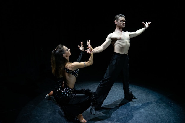 Ballroom couple dancing isolated on black.