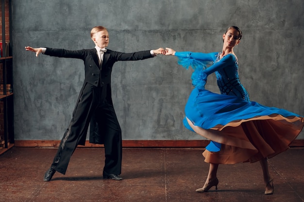 Ballroom dance. Young man and woman dancing foxtrot.