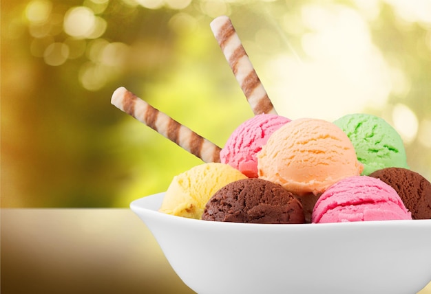 Balls of delicious ice cream on blurred background