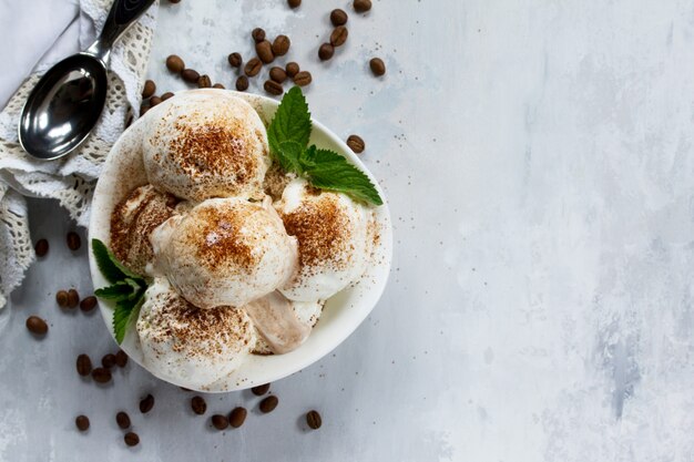 Balls of ice cream in a bowl with a spoon