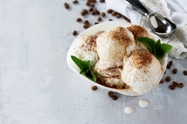 Balls of ice cream in a bowl with a spoon