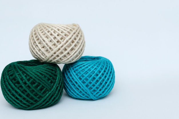 Balls of jute yarn on white background