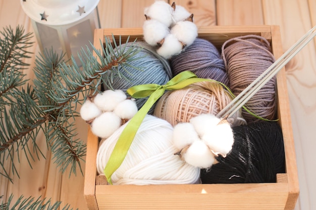 Balls of thread in a wooden box folded in tones Wool yarn