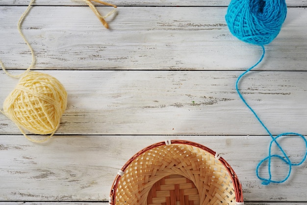 Balls of woolen thread on a wooden background top view