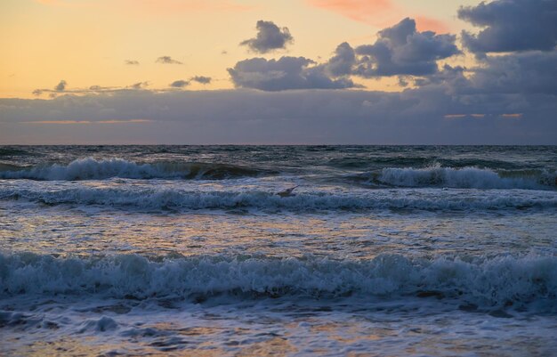 Baltic sea against dramatic cloudy sky at sunset