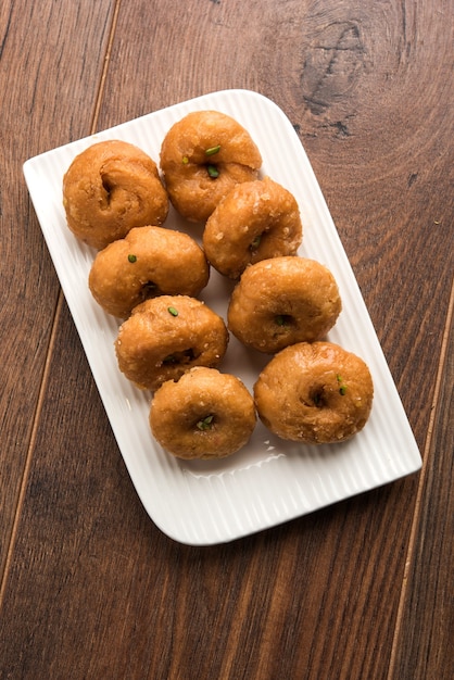 Balushahi sweet food served in a white or golden plate over moody background