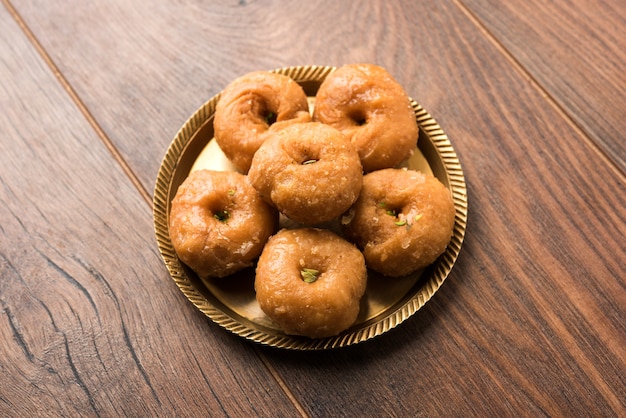 Balushahi sweet food served in a white or golden plate over moody background