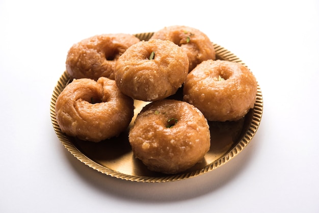 Balushahi sweet food served in a white or golden plate over moody background