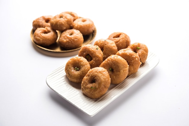 Balushahi sweet food served in a white or golden plate over moody background