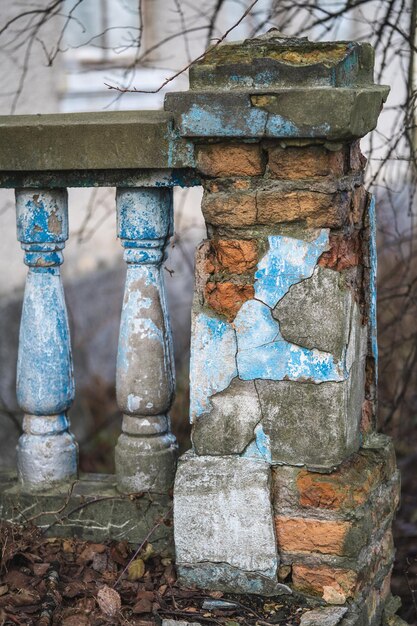 A balustrade on the railing of an old cracked staircase