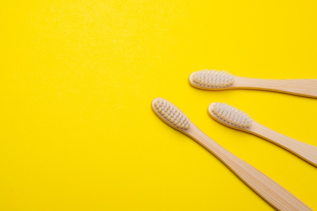 Bamboo brushes on a yellow surface