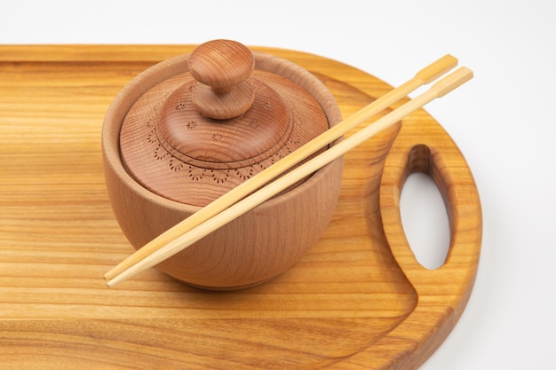 Bamboo chopsticks lie on wooden utensils items for food