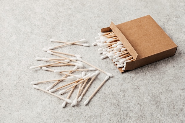 Bamboo cotton buds in carton box. Ethical, sustainable, no plastic lifestyle idea. Top view, mockup