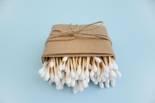 Bamboo cotton buds in paper box on blue table