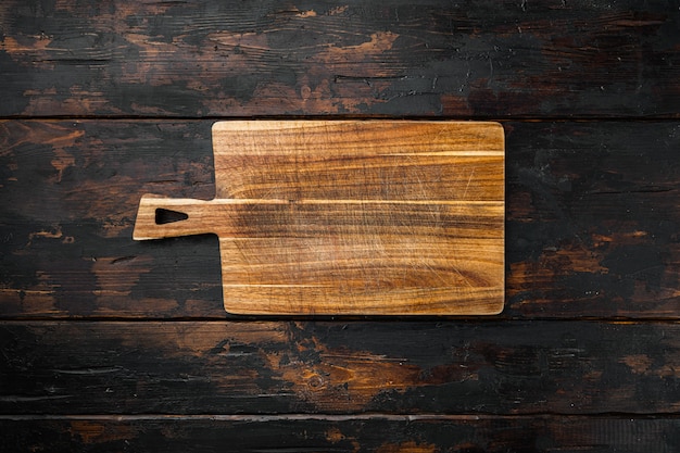 Photo bamboo kitchen cutting board set empty for empty for copy space for text or food, top view flat lay, on old dark  wooden table background