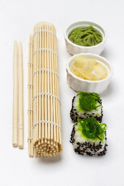 Bamboo mat eetstokjes zeewier sushi gember en wasabi