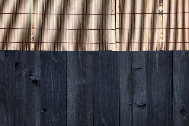 Bamboo mat on wooden table, top view