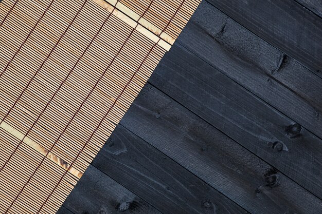 Bamboo mat on wooden table, top view